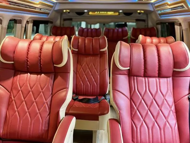 Red leather captain seats inside the VIP van